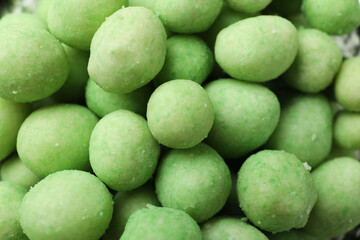 Tasty wasabi nuts on whole background, close up