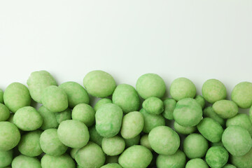 Group of tasty wasabi nuts on white background