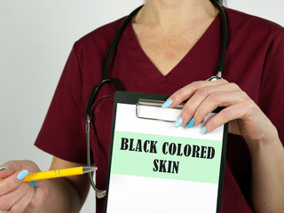 Healthcare concept meaning BLACK COLORED SKIN with inscription on the piece of paper.