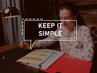  KEEP IT SIMPLE phrase on the screen. Broker analyzing market research results.