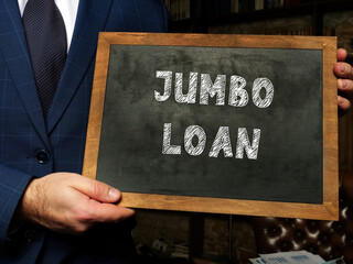 Business concept about JUMBO LOAN with sign on chalkboard in hand.