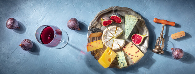 Cheese and wine tasting panorama with various cheeses. Panoramic header with Brie, blue cheese and...