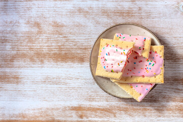 Strawberry pop tarts, shot from the top on a rustic wooden background with a place for text - obrazy, fototapety, plakaty
