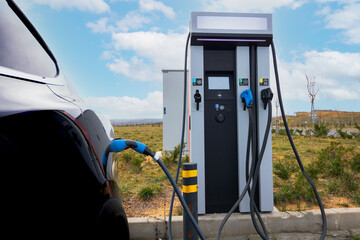 electric car plugged in to EV Charger station