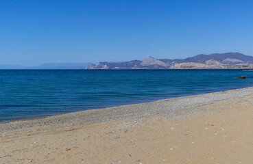 Calm sea and empty sandy beach in Kapsel Bay. Crimea.