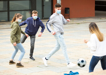 Teenagers play street football with excitement on the street