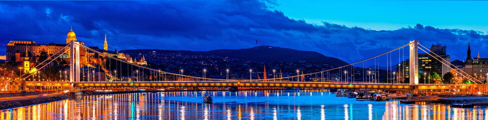 Budapest at night, Erzsebet bridge on the Danube river, reflection of night lights on the water, panoramic shot