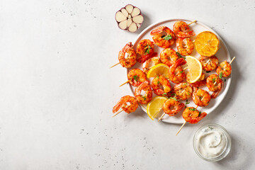 Grilled shrimp with garlic and lemon on white background