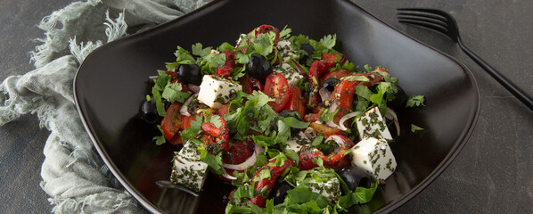 Fototapeta na wymiar flat lay of salad plate with feta cheese, cherry tomatoes and baked peppers on dark table, square