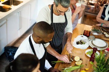 Group of friends cooking in the kitchen
