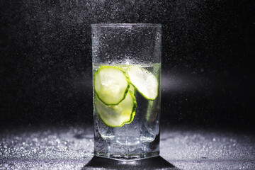 Cucumber water. Drinking water with fresh cucumber. Mineral water. Healthy, mineral-rich, refreshing water with cucumber.