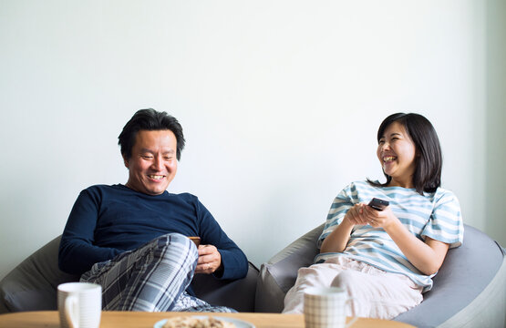 Asian Couple Watching Movie At Home Together