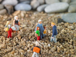miniature figures of people walking down the street with a white hermitage in the background