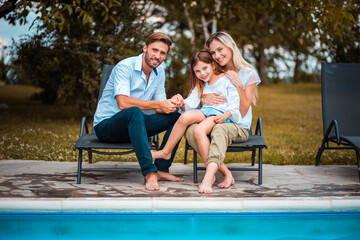 Fototapeta na wymiar Happy Family sitting by the pool.