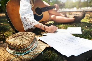  Closeup of woman guitarist sitting composing music in the park © Rawpixel.com