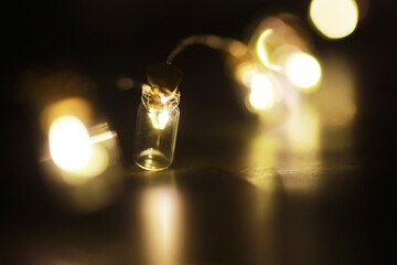 Christmas garland of glass bottles. New year and christmas concept. A garland of light bulbs with a beautiful light and bokeh