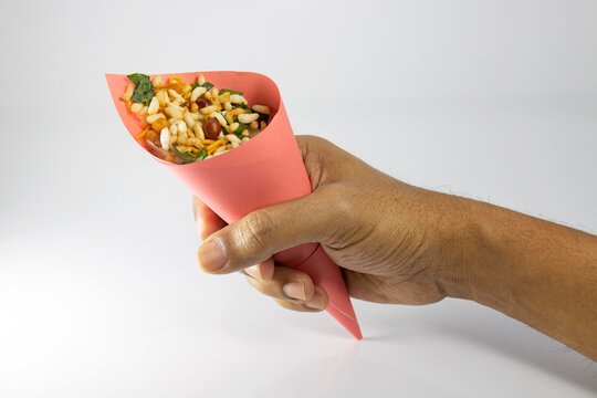 holding Jhal Muri in hand.