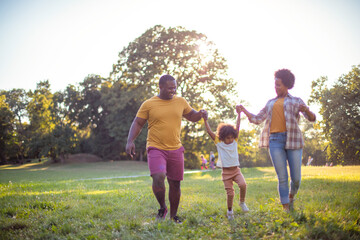  African American family having fun outdoors.
