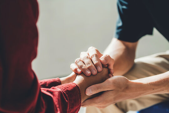 Man holding a woman's hand for warm, as psychological counseling concept of support, understanding care in love, Concept about encouraging and fighting problems.