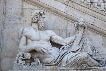Fototapeta premium Ancient marble statue of the god of the river Tiber, protecting Romulus and Remus with his right arm, from the Capitoline Hill Square, Rome.