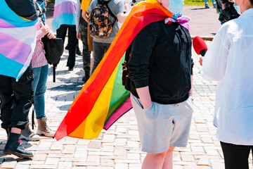 LGBT activist wrapped in flag taking a part in interview and talks something in microphone....