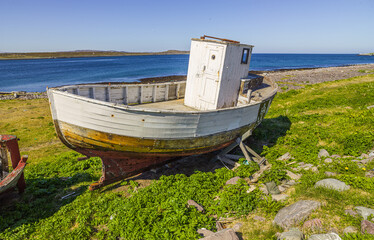 Fototapeta na wymiar Old and dilapidated wooden fishing boat on the shore at Vardö, Finnmark, Norway