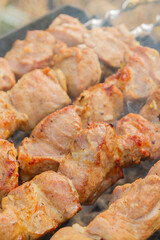Shish Kebab made from pieces of pork is cooked on skewers on the grill