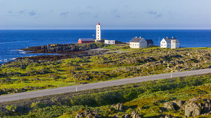 Fototapeta na wymiar Kjolnes lighthouse at the rocky Barents sea coast in the vicinity of Berlevag, Finnmark, Norway