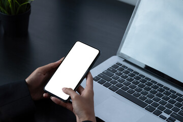 Woman using smartphone frameless mockup with blank screen in home office