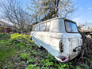 Old broken bus at a car dump.