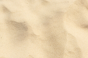 Fototapeta na wymiar Natural yellow sand on the beach background