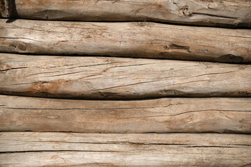 Wooden board texture of the wooden background. horizontal round old logs