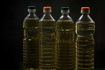 Sunflower oil bottles stand on black table