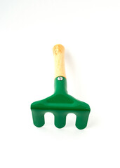 Small garden rake isolated on white background.