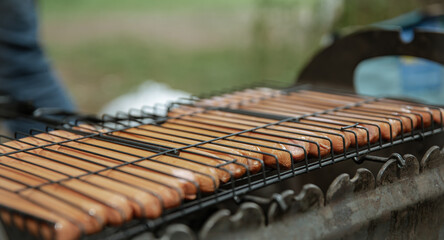 Close-up of hot dog sausages being cooked on the grill.