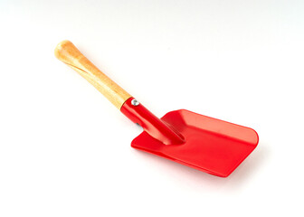 Small red color shovel isolated on white background.