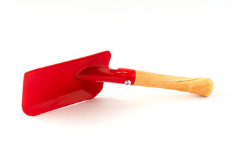 Small red color shovel isolated on white background.