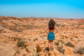 Portrait of a happy brunette woman in the Valley of Fire in Nevada overlooking a desert landscape