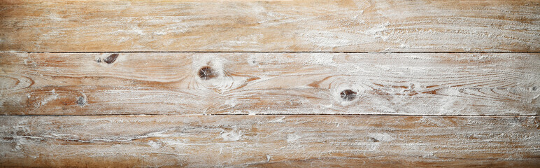 Background. Floured wooden surface of old rustic kitchen, pastry board. Top view, space for text.