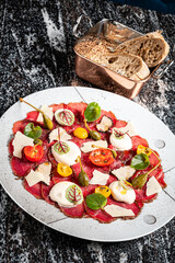 beef carpaccio with cheese and vegetables