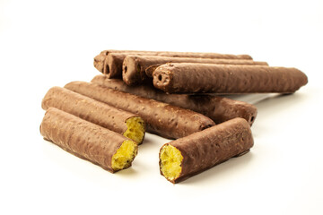 Bars of corn sticks in chocolate on a white background in a close-up with shadows isolated