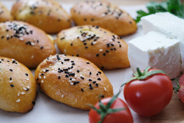 Sesame and black cumin puffs feta cheese and cherry tomatoes.