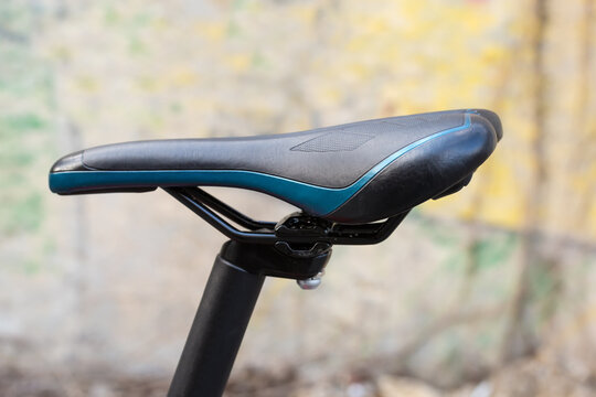 Leatherette saddle of modern bicycle on a blurred background
