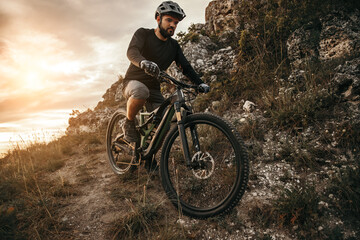 Fototapeta na wymiar Bearded man riding bicycle in mountains