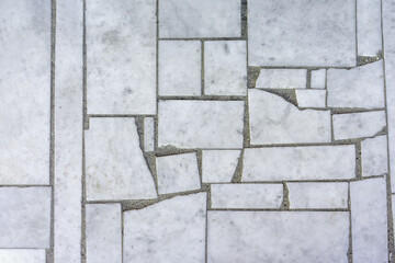 background cracked marble tiles on the sidewalk top view