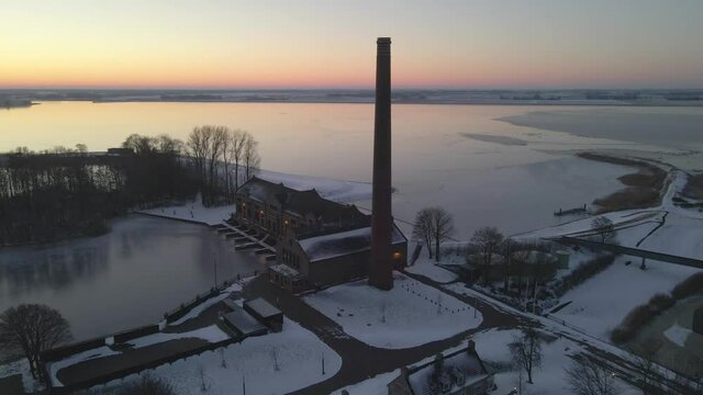 Brick tower for steam ovens at water pumping station during magical sunrise