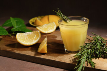 Alcoholic drink limoncello. Fresh lemons and shot glass of limoncello on table. Top view.