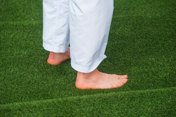 Photo of man with naked foot sitting on fresh green grass