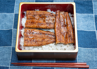 Japanese grilled unagi eel on rice in a lacquered lunch box 