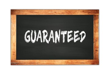 GUARANTEED text written on wooden frame school blackboard.